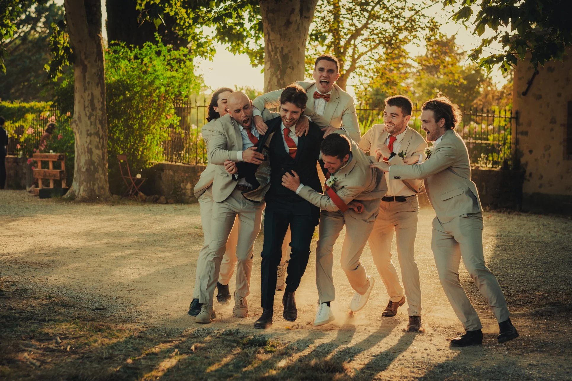 Groom and groomsmen having a fun moment during their group photo.