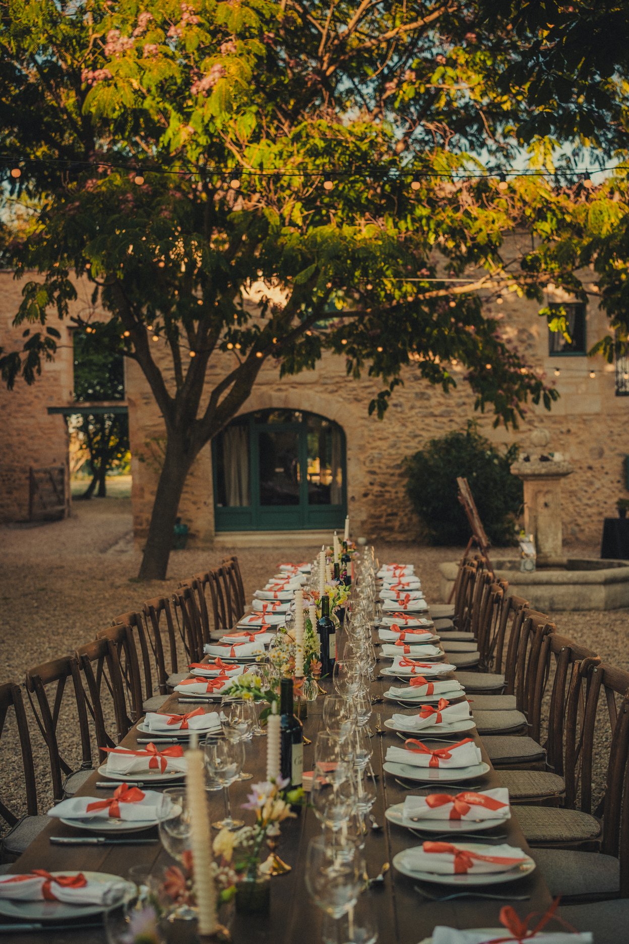 Outdoor long dining table at the wedding with decorations at Domaine Arbaud in Provence.