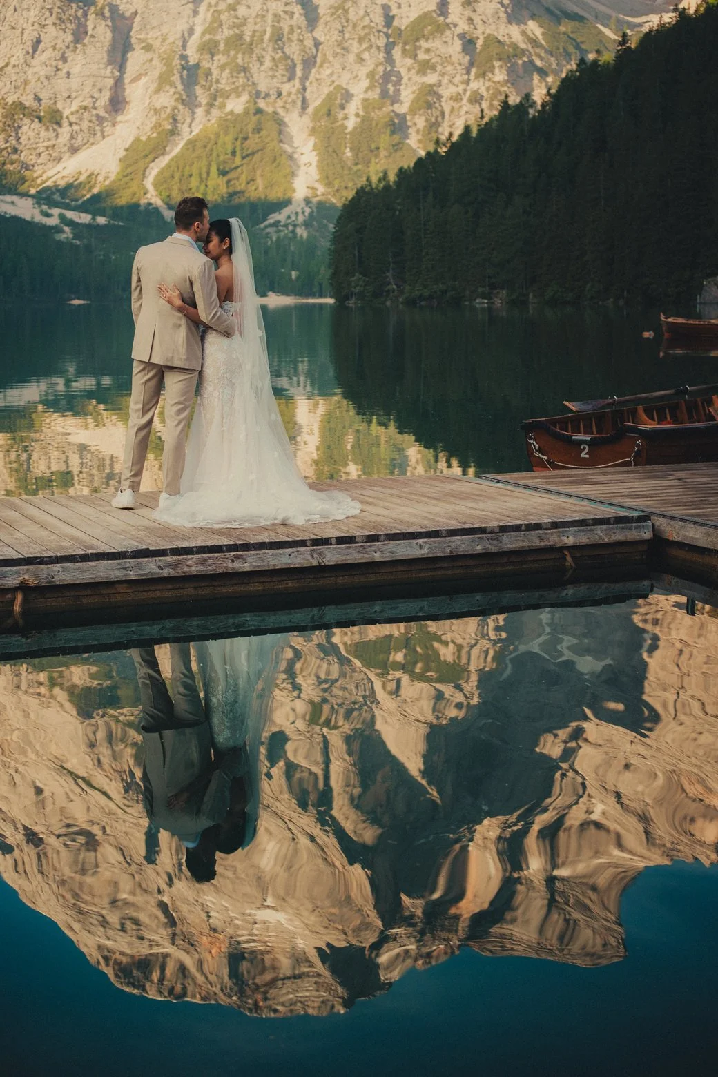 Lago di Braies elopement photographer capturing vows moment at the boathouse