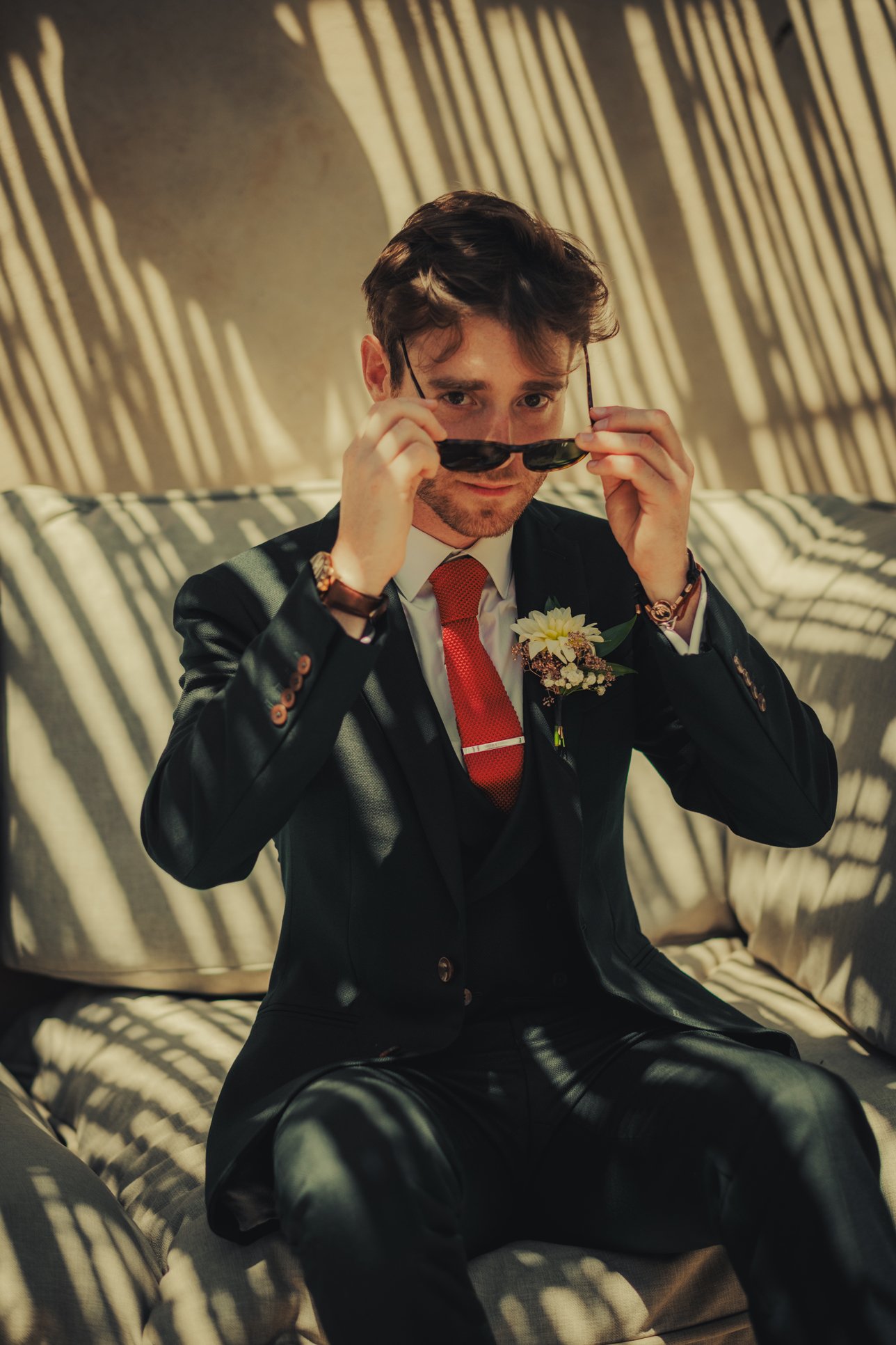 A cool portrait of groom with sunglasses in the early afternoon.