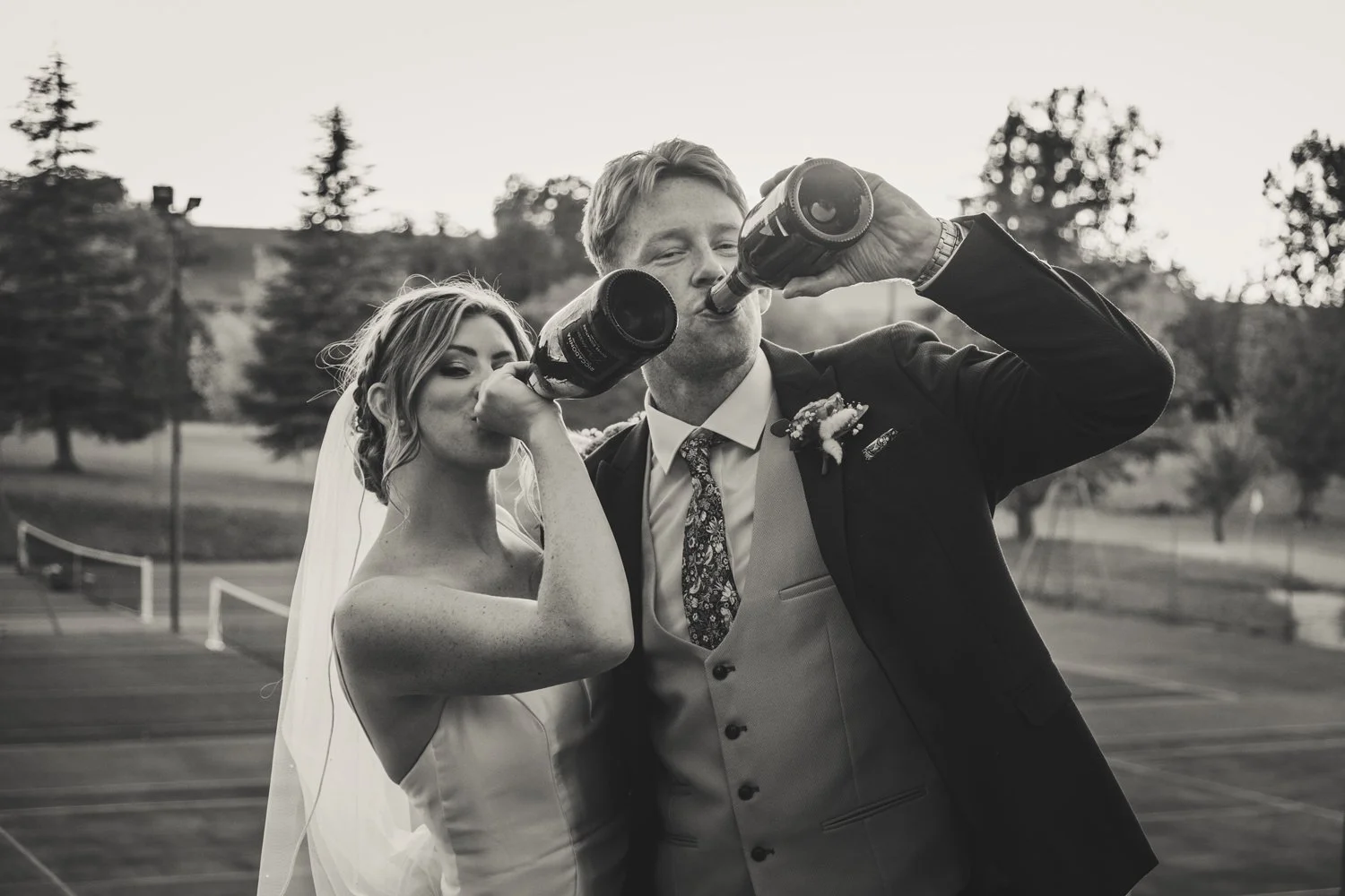 bride groom drinking champagne bottle fun