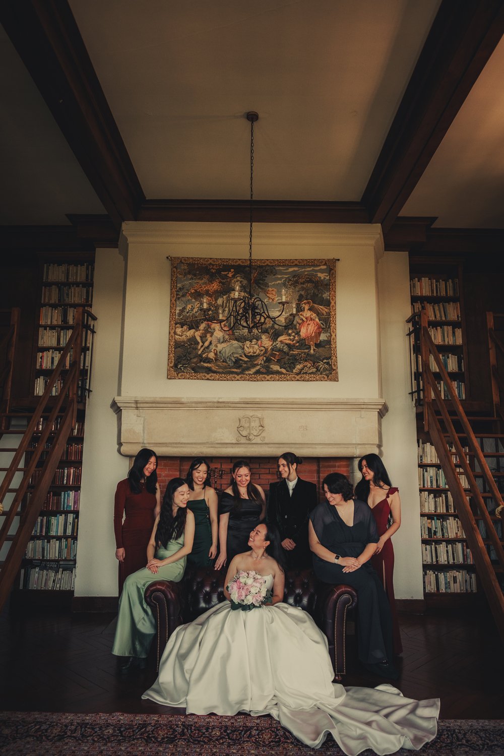 A group portrait of bride and her friends in the library of Chateau du Doux.