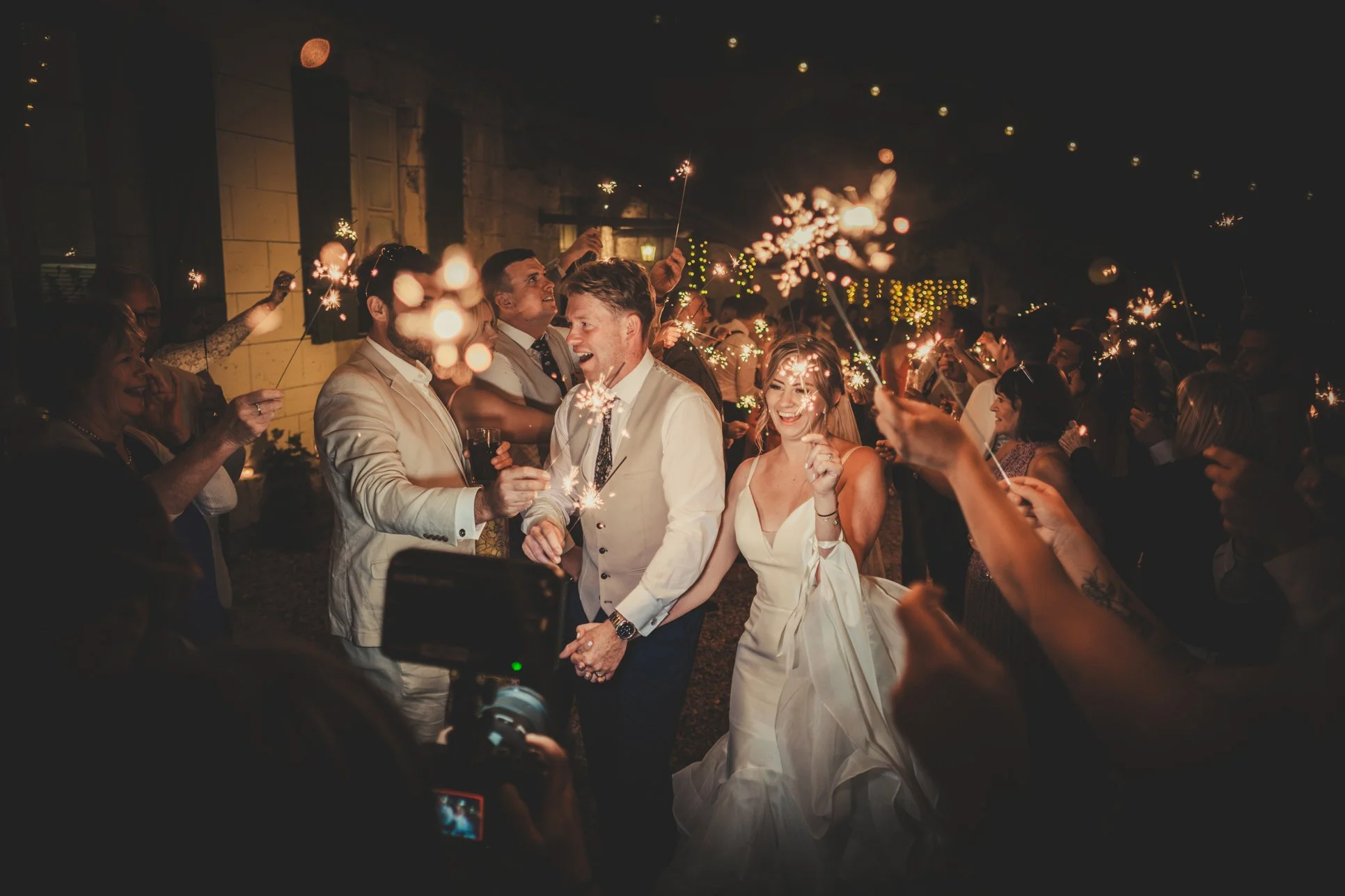 bride groom walking through sparklers