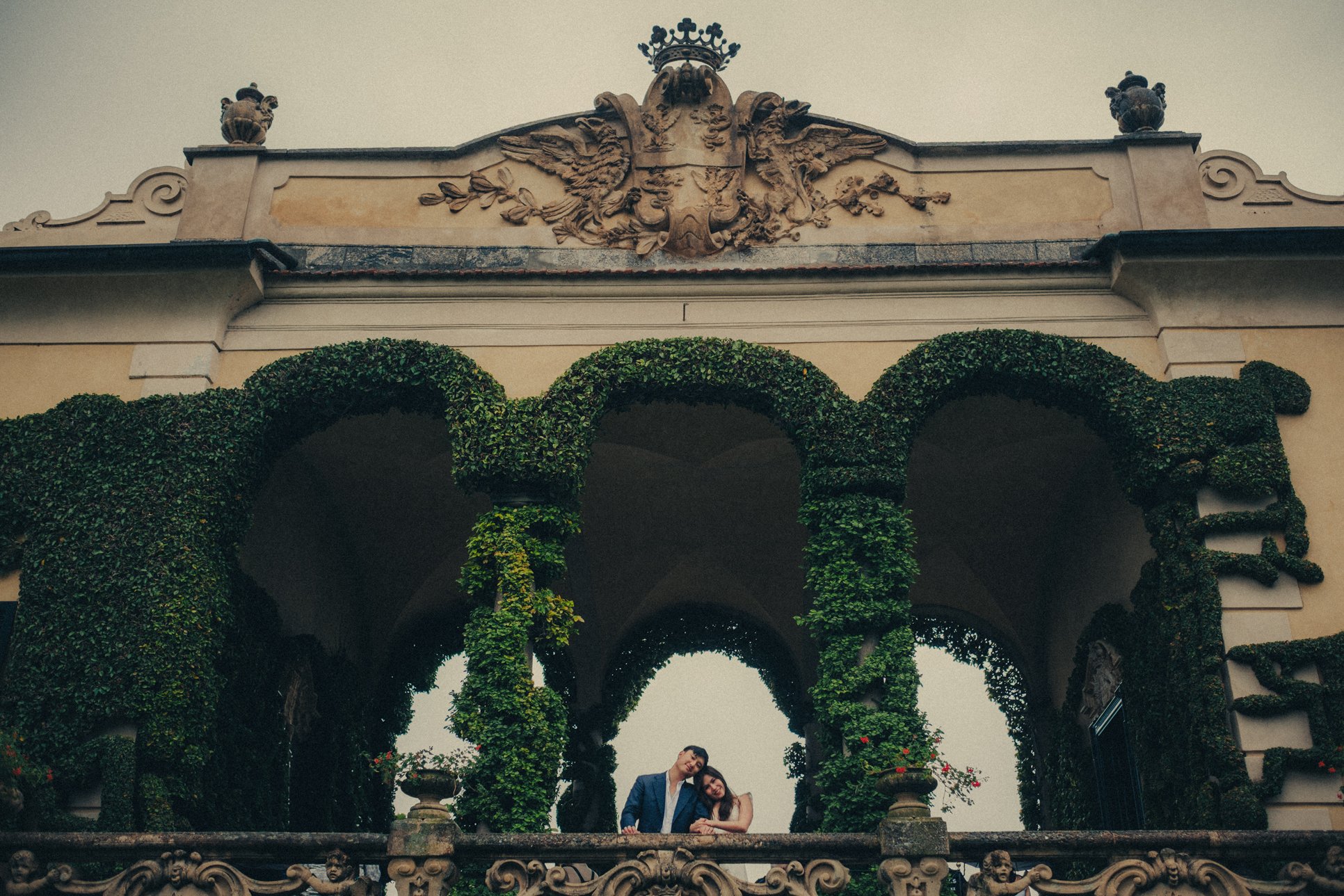 Couple posing on the balcony of Villa del Balbianello during their engagement session.