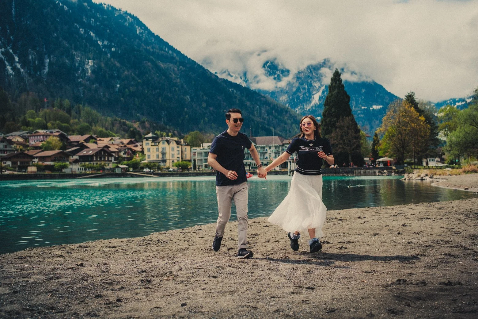Natural couple portrait by Lake Brienz during a spring honeymoon in Switzerland.