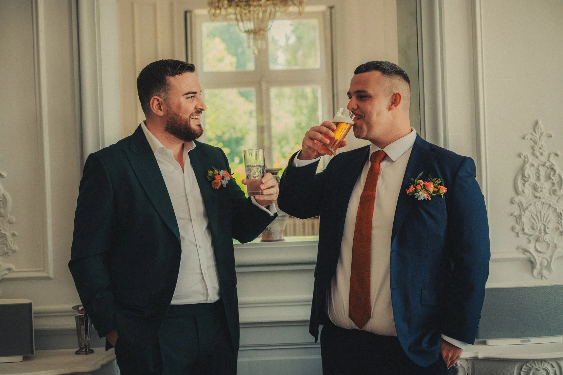 Groom preparing for ceremony inside château wedding venue
