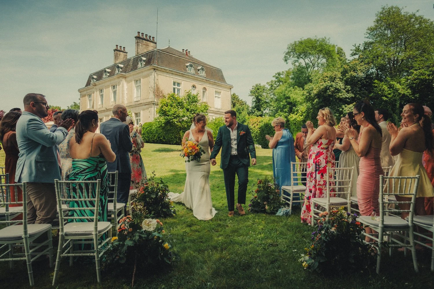 Outdoor wedding ceremony with château backdrop in Dordogne
