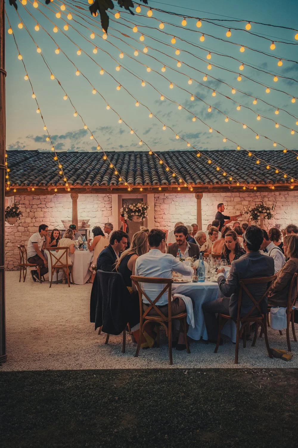 Provence wedding outdoor dinner atmosphere with many garlands during the night.