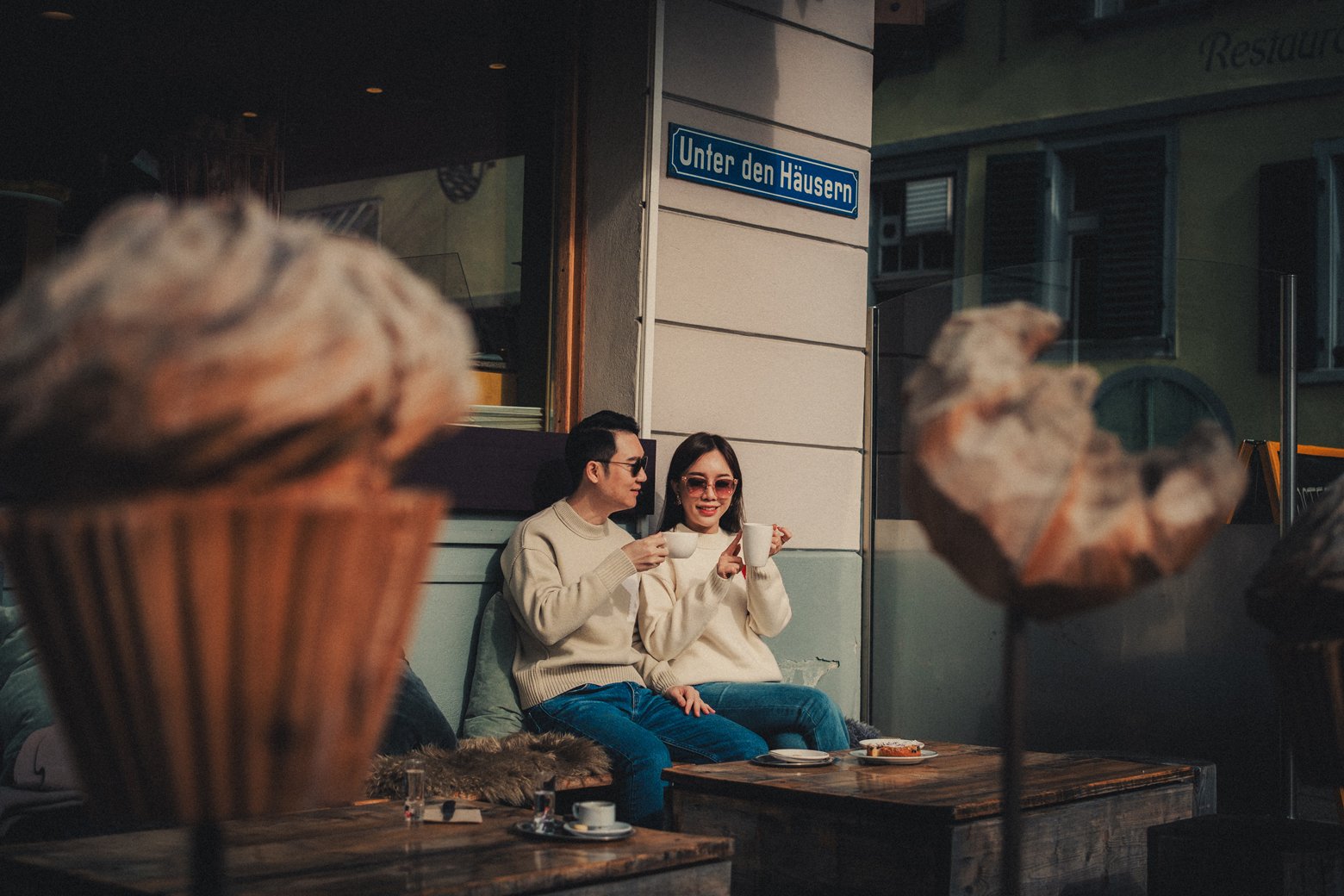 Couple enjoying their morning coffee at a local bakery during their honeymoon in Interlaken, Switzerland.