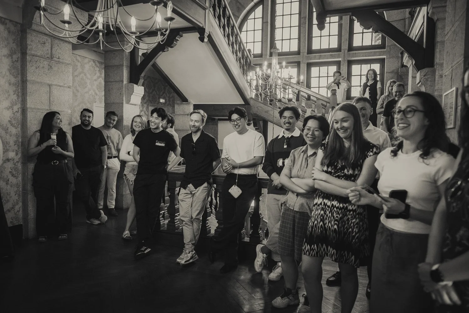Guests gathering to cheer for the groom playing the traditional Chinese door game at the wedding in France.