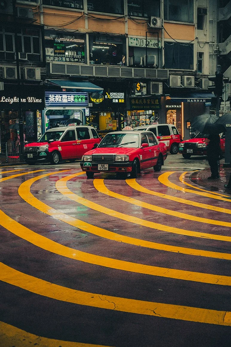 Hong Kong elopement photographer capturing taxis on the road on the street.