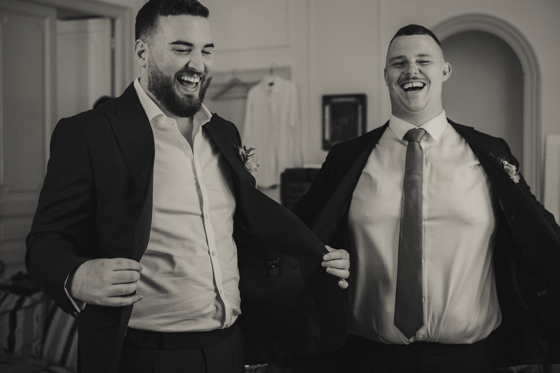 Groom getting ready with best friend before wedding ceremony