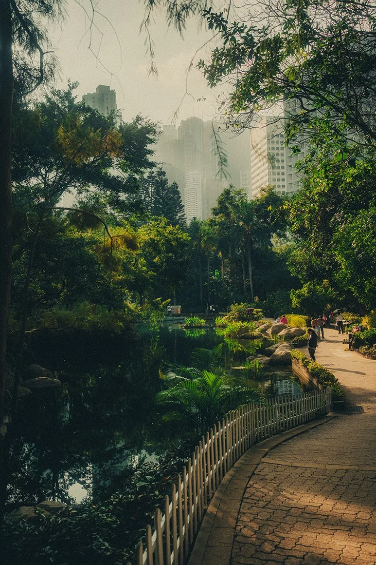 Hong Kong city park in the morning with tall buildings.