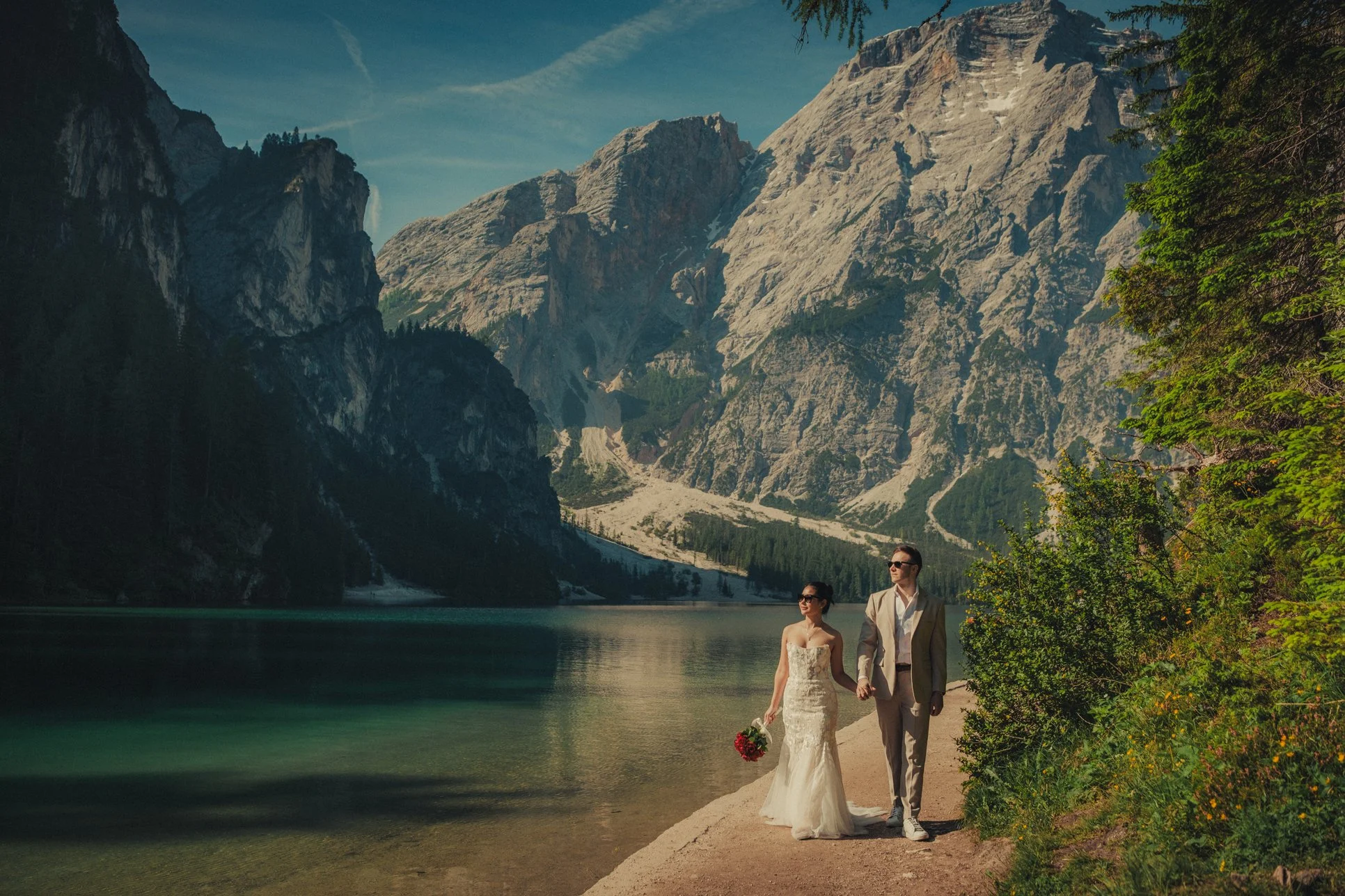 Lago di Braies elopement photographer capturing couple walking around the lake
