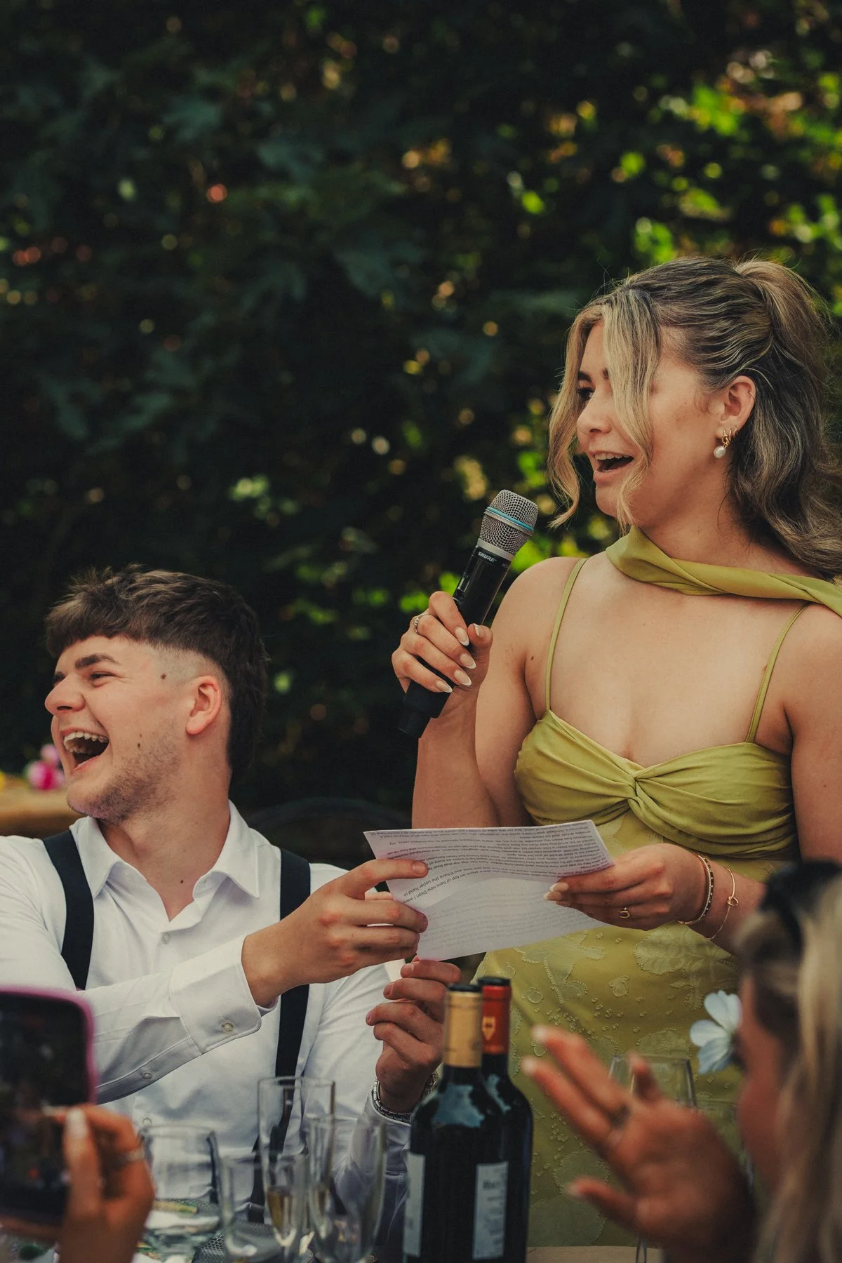Guests giving a funny speech to the couple at the dinner time at chateau du Raysse.