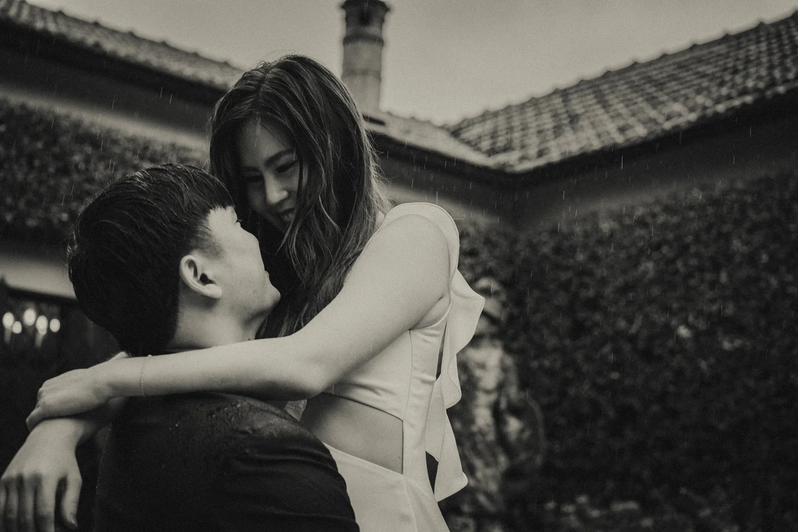 Couple embracing the rain during their engagement photo session in Lake Como.