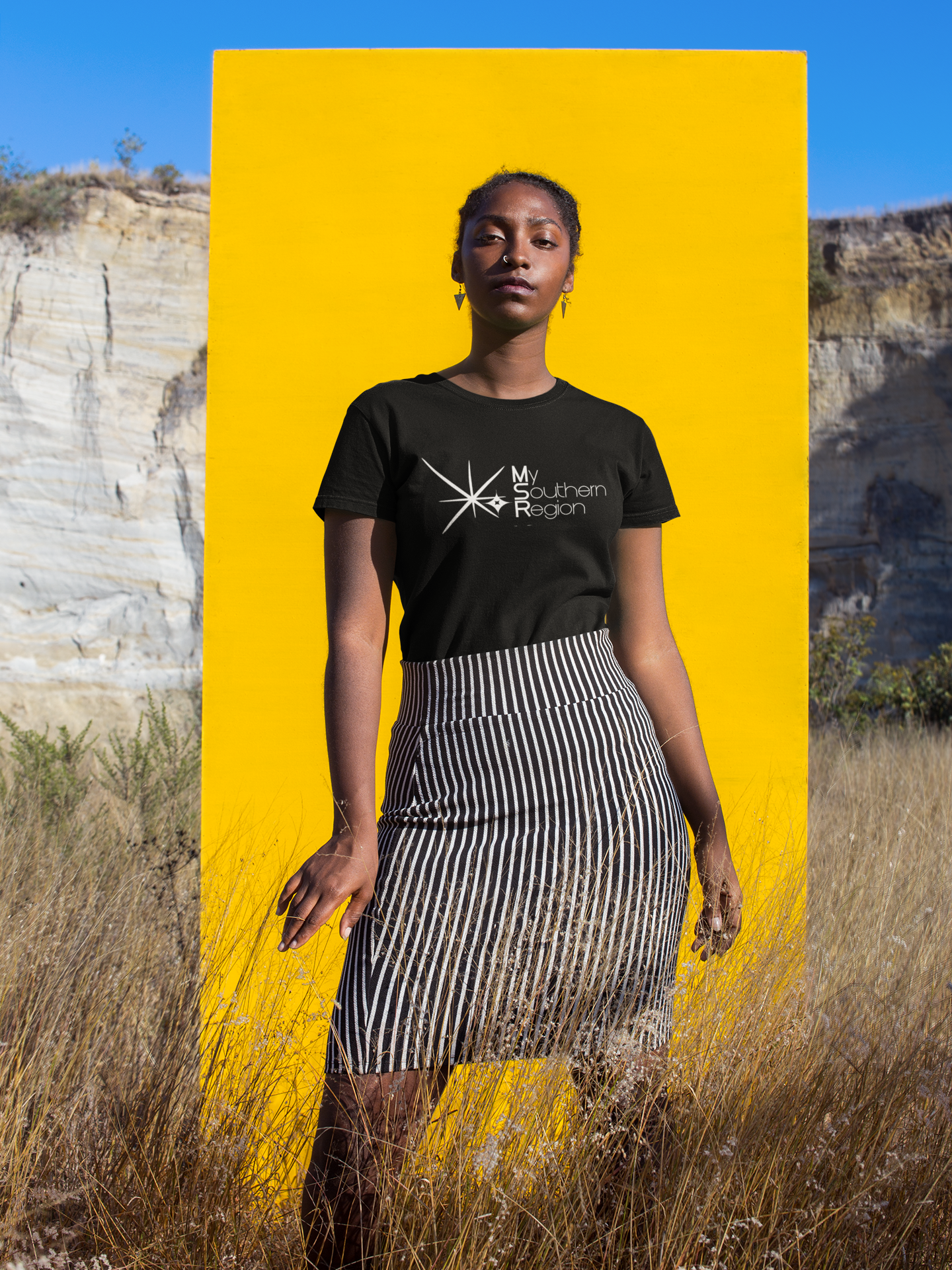 beautiful-woman-standing-against-a-yellow-rectangle-wearing-a-tshirt-mockup-a18570.png