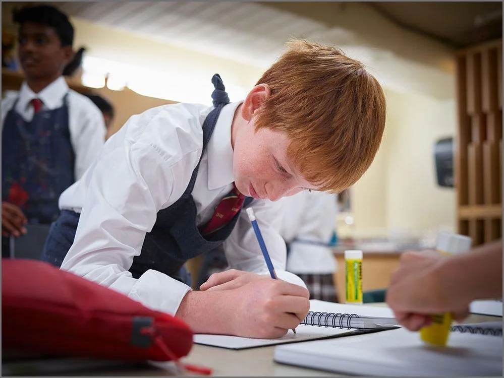 private school student writing in sketchbook.jpg
