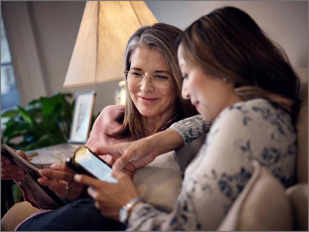  lifestyle advertising two women on couch smiling.jpg