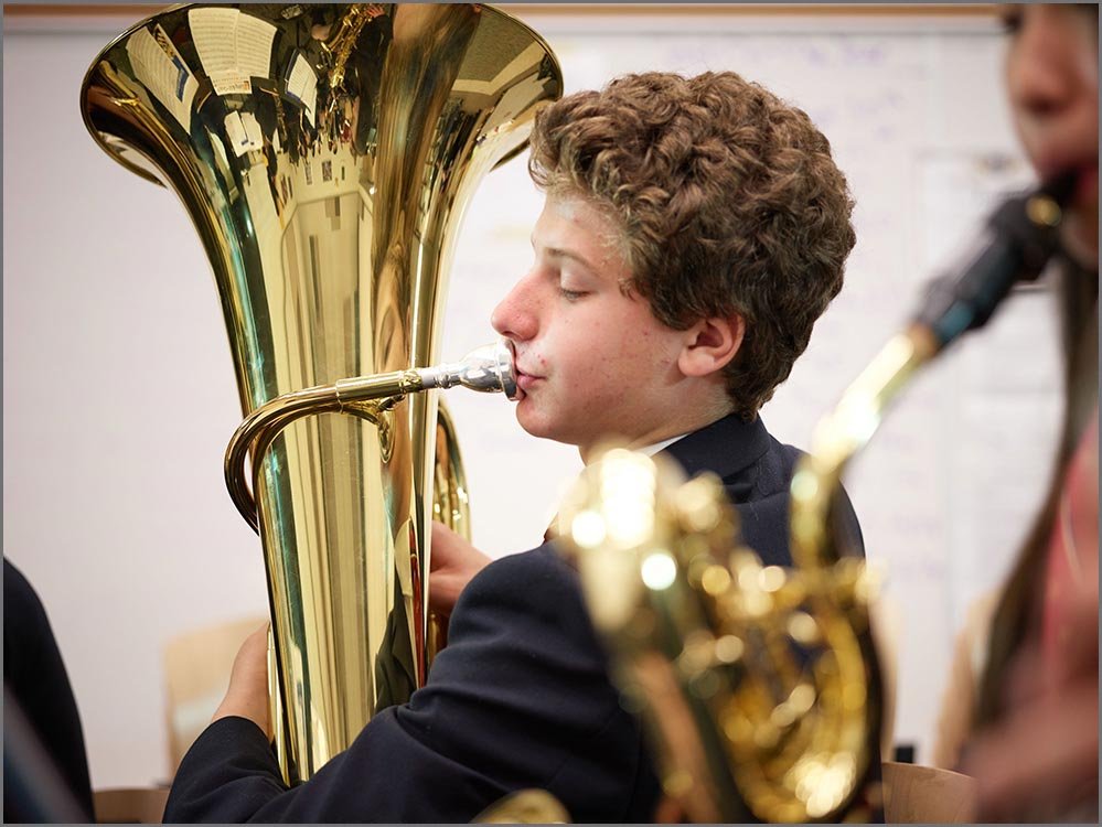 private school student playing horn instrument.jpg