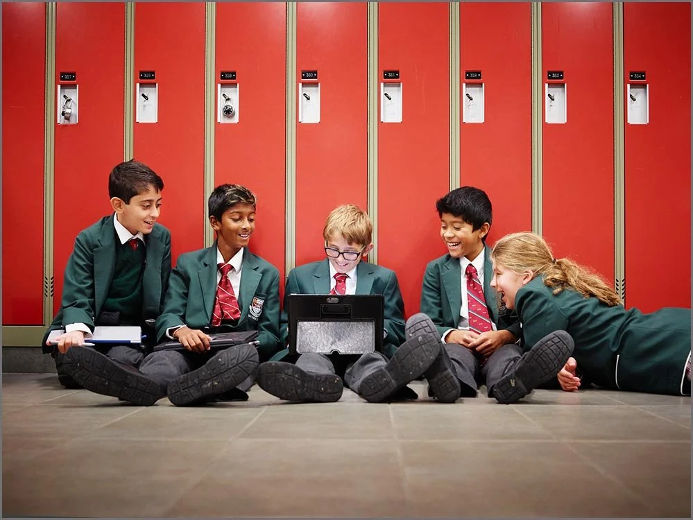 private school group of children sitting near lockers.jpg