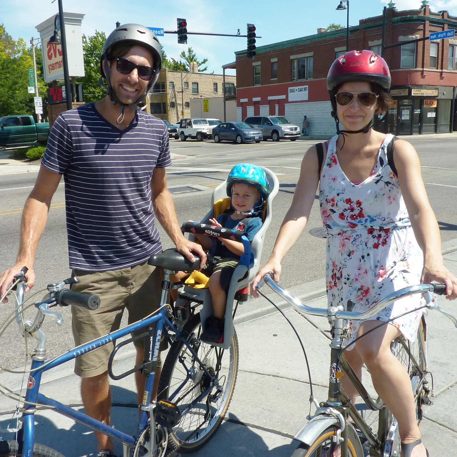 Father, mother and baby on bicycles.