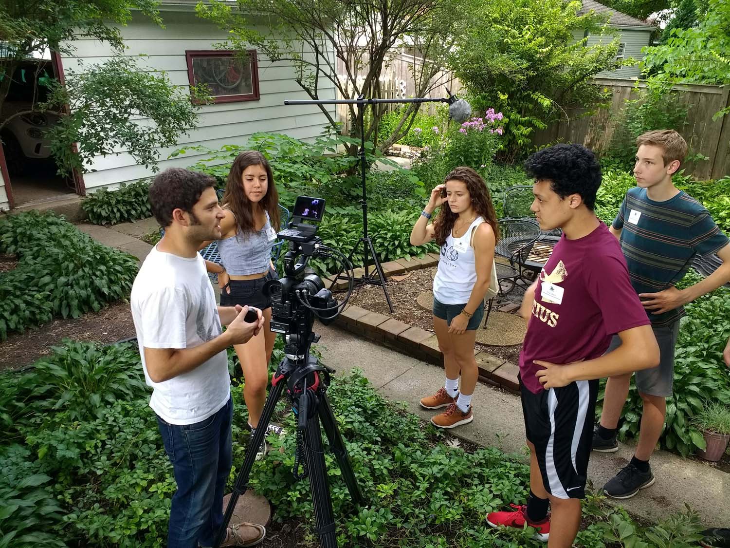 Matt Wechsler of Hourglass Films helps students prepare for an outdoor interview in Estelle Carol’s lush garden.