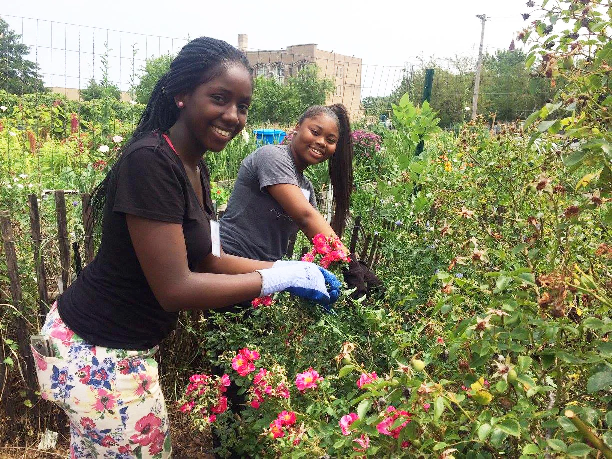 Two students gardening during our inaugural summer youth program in 2017.