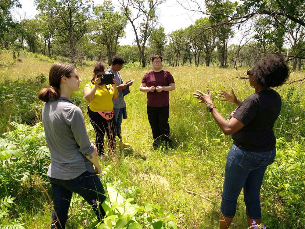 Johari Cole (right) gives background about the landscape.