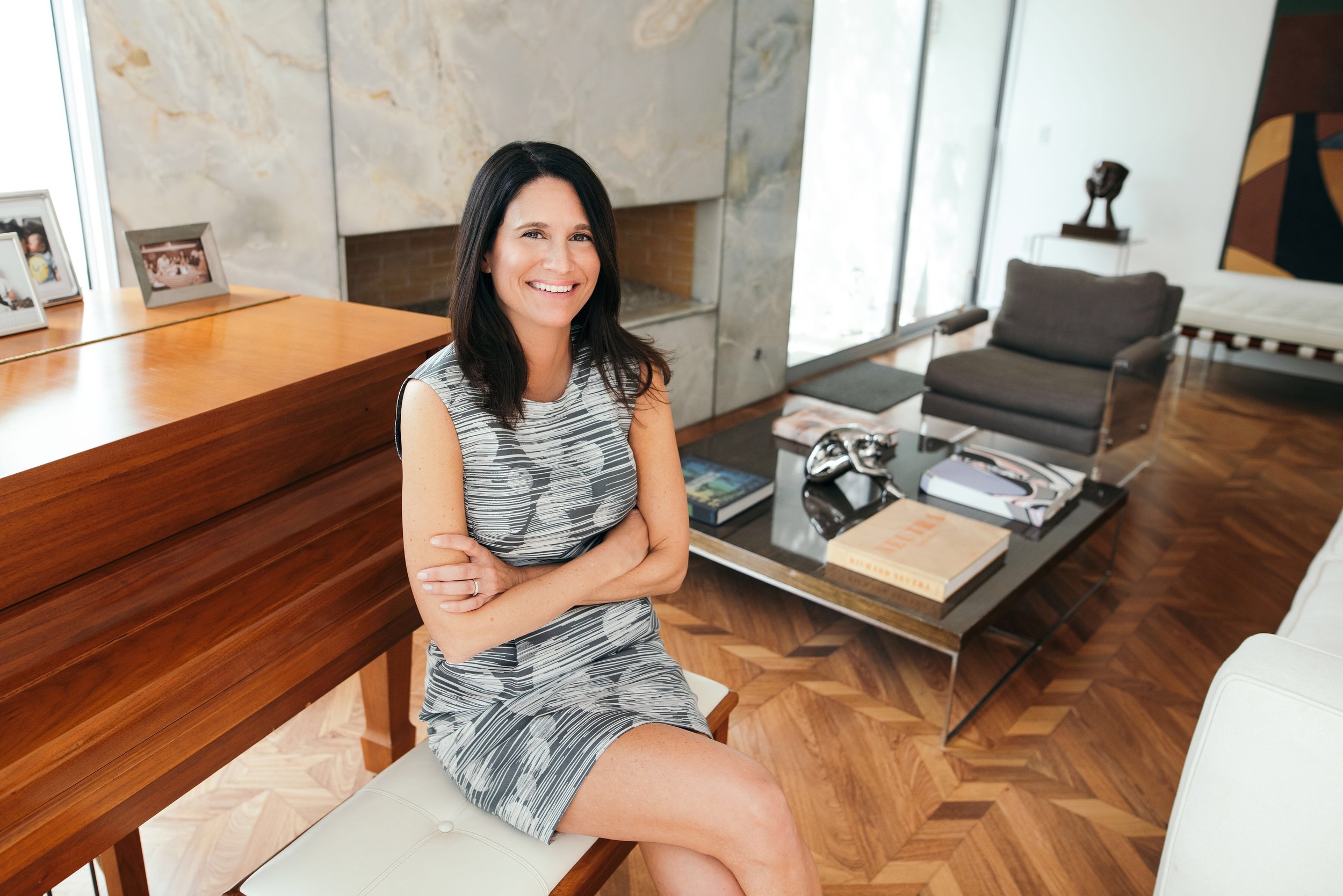 Madeleine Perez seated in a Los Angeles home interior, representing buyers and sellers across the local real estate market.