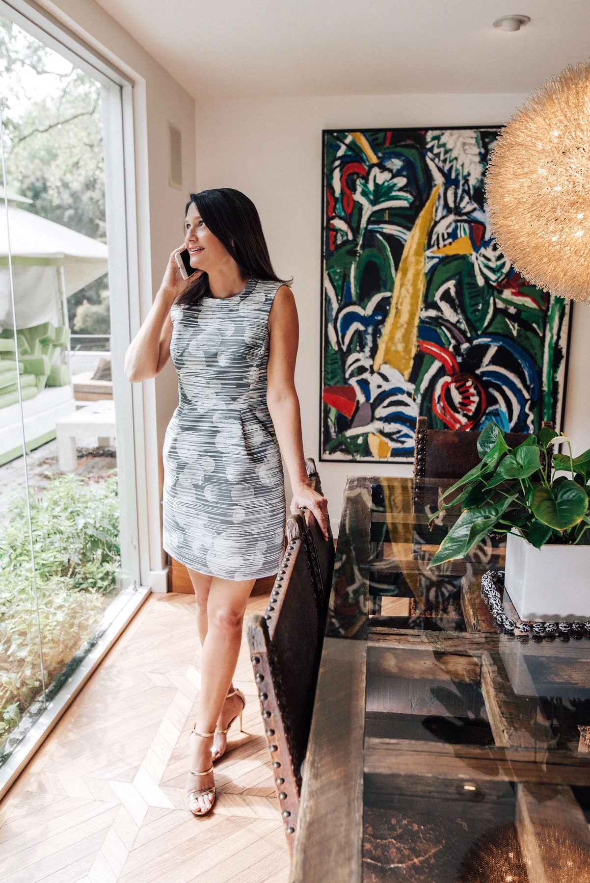 Madeleine Perez standing in a bright interior while speaking on the phone.