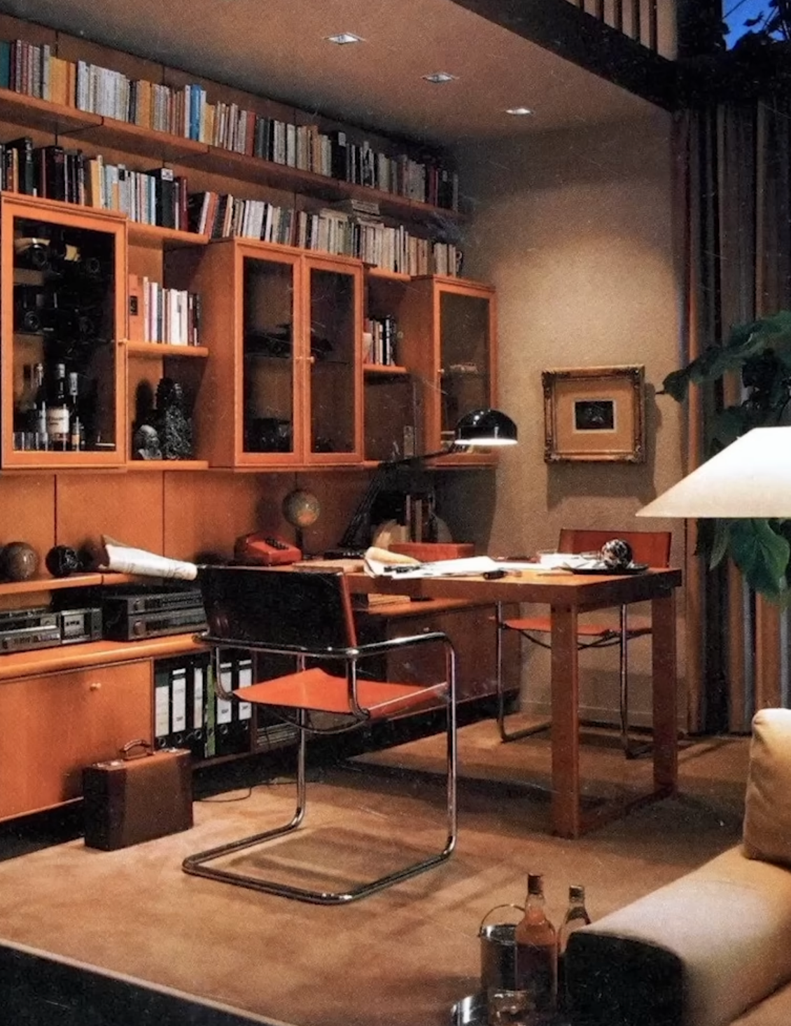 Mid-century modern library and game table with warm lighting