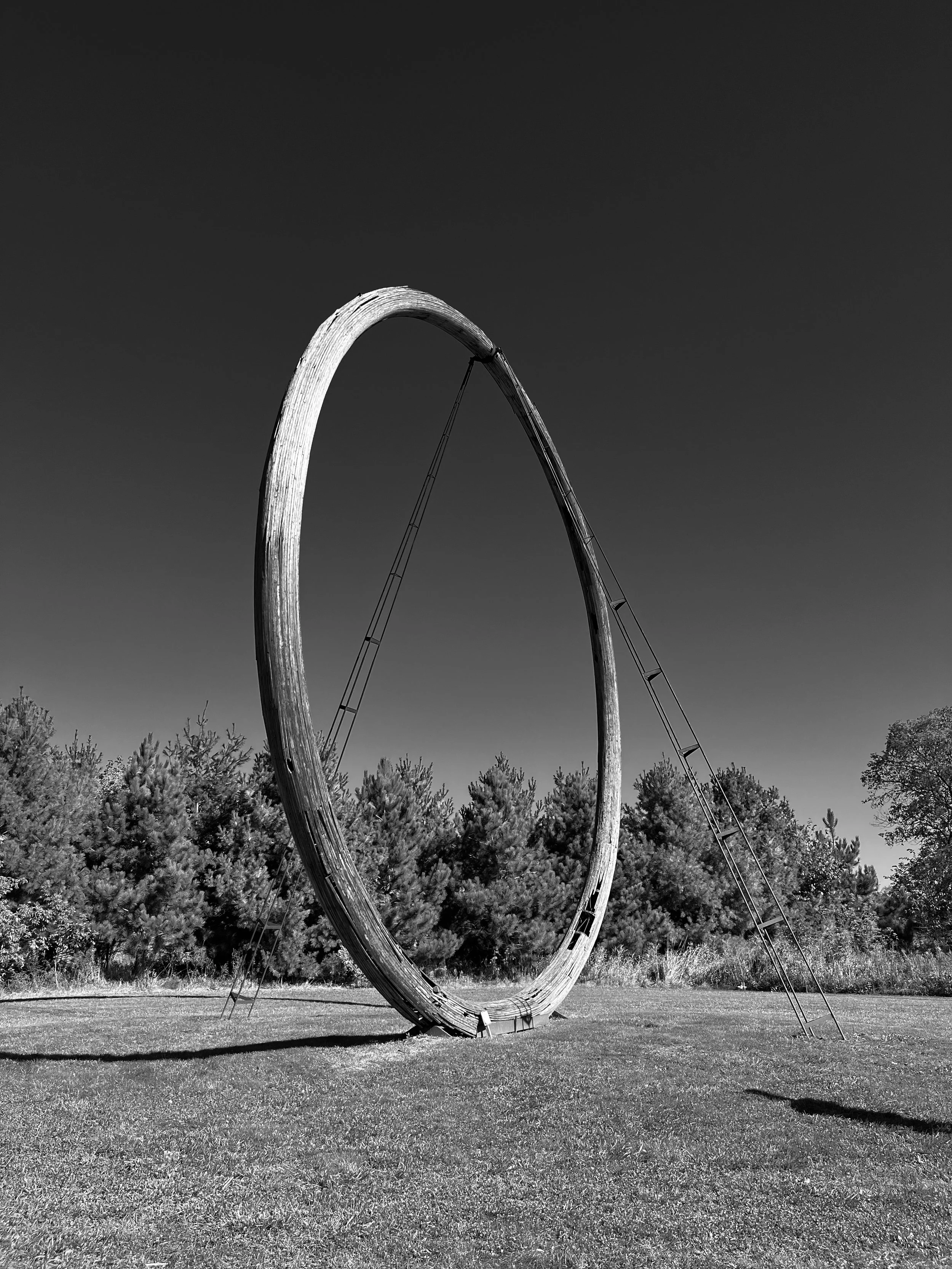 Large circular freestanding sculpture in a field