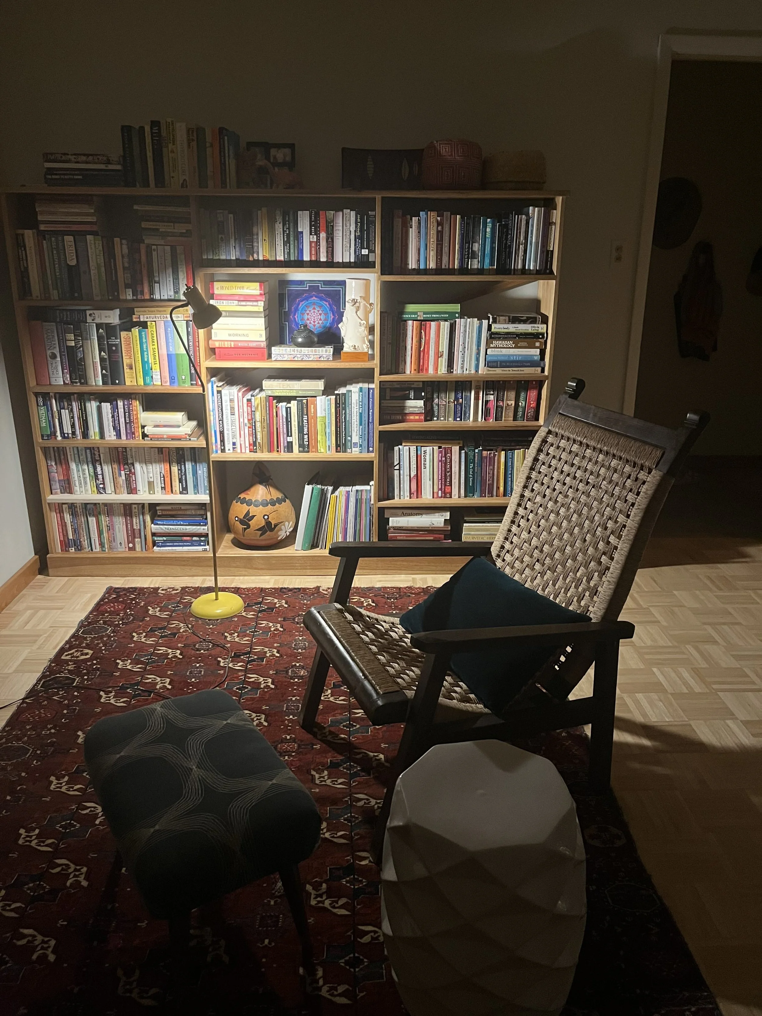 A cozy corner library with chair and lamp
