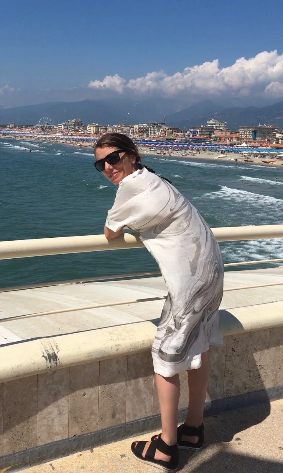 Women standing on a the Viareggio pier in a dress from The Summer House