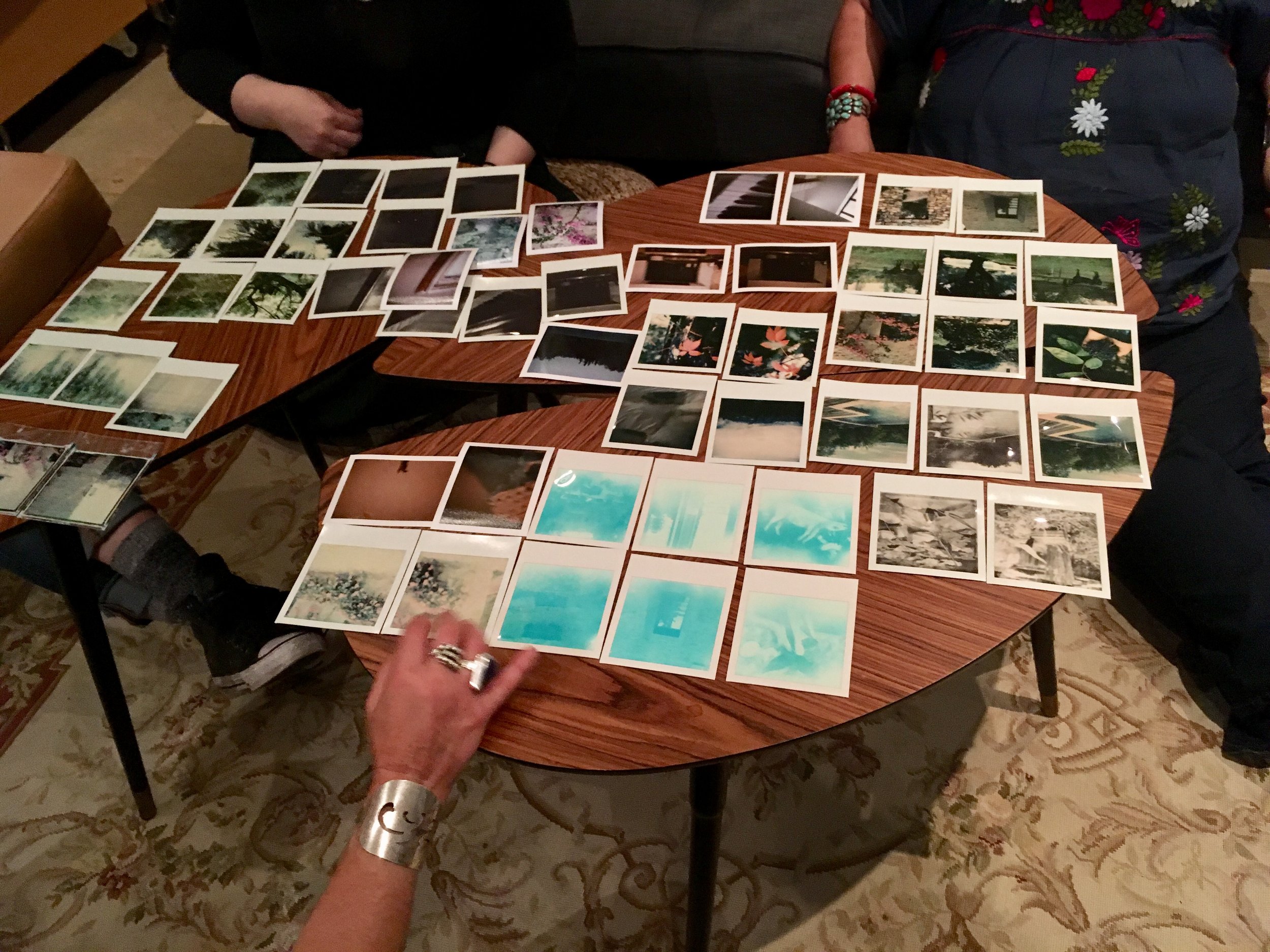 poloroid photos spread out on a table