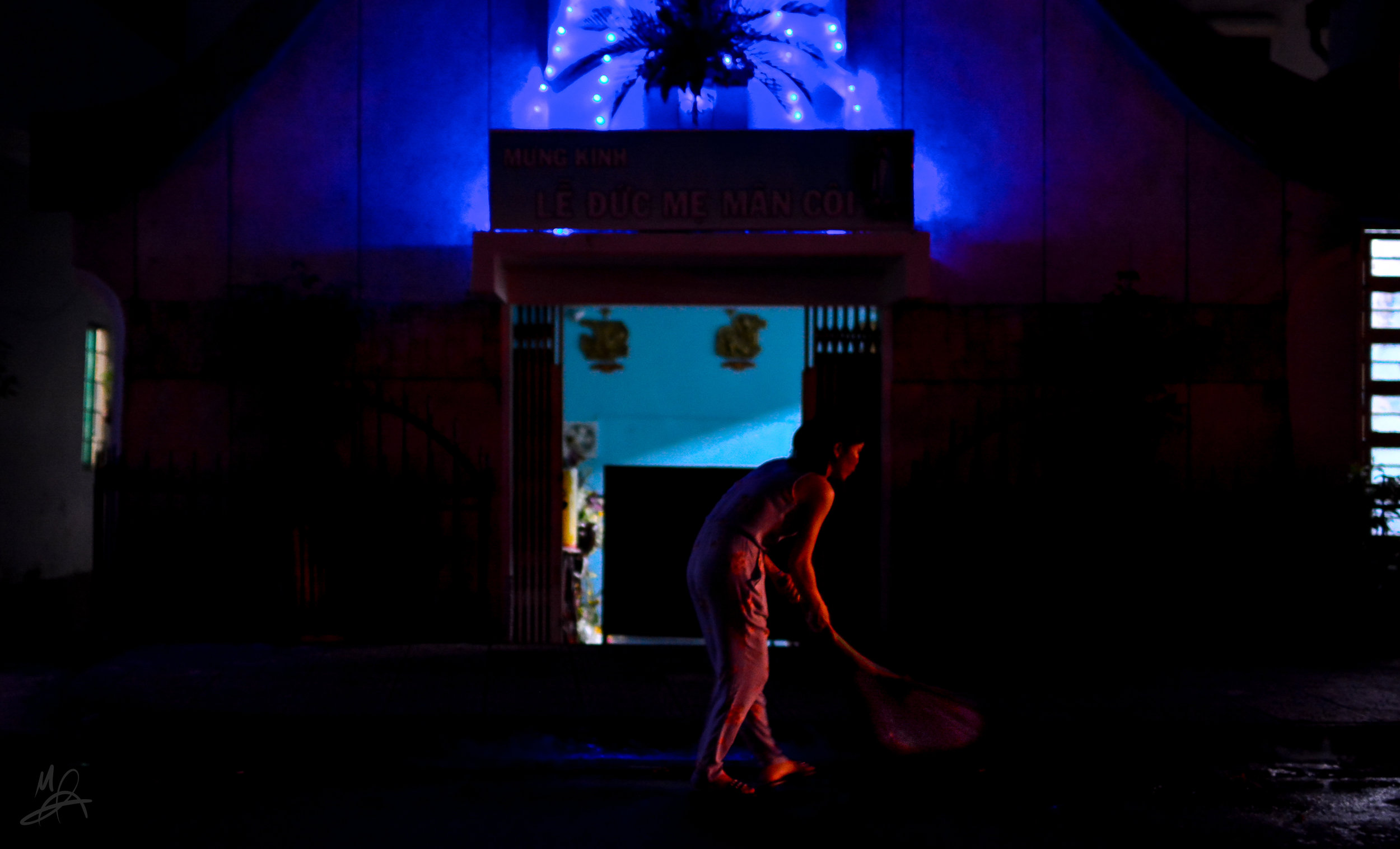 A woman sweeps outside a church