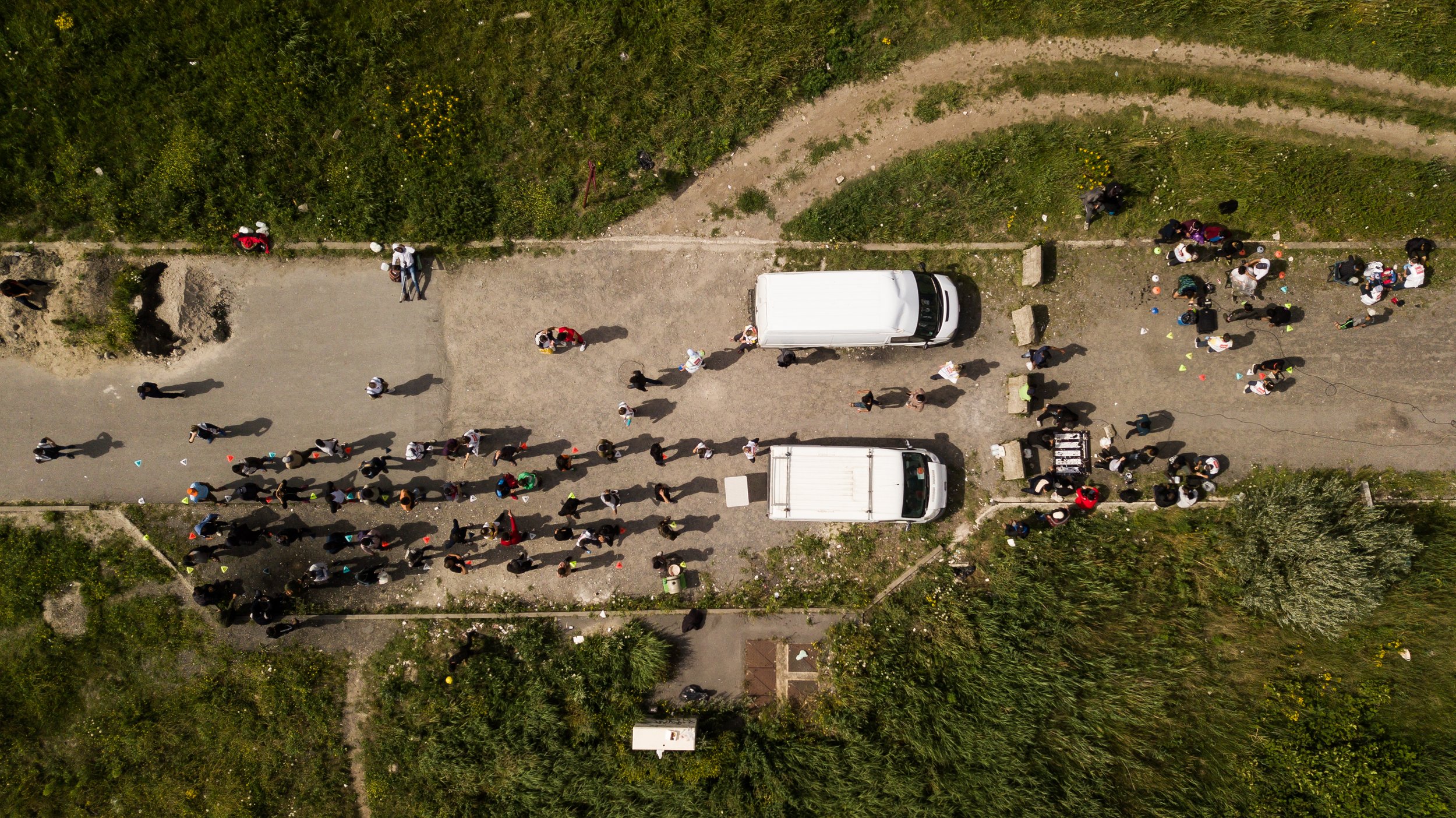  At the 'Afghani Hospital' site, people wait for a variety of services, such as first-aid, haircuts and hot drinks.  Care4Calais prep everything for distribution and services from their warehouse in the morning, before meeting refugees in the afterno