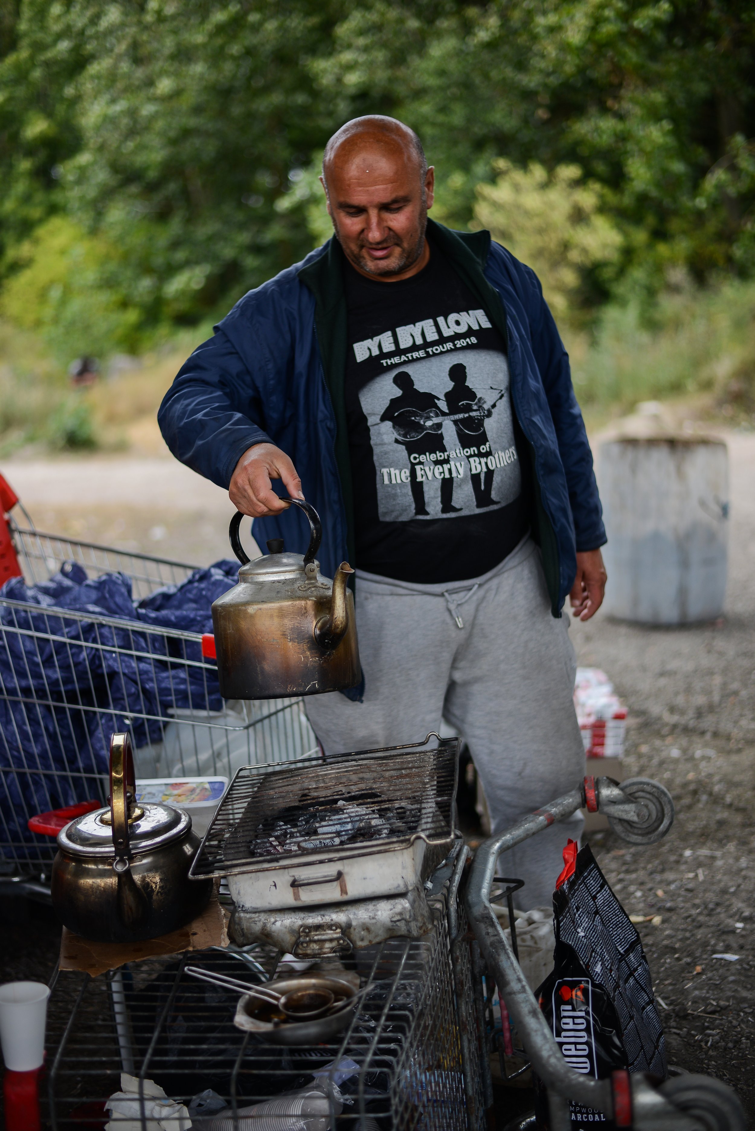  A Kurdish man makes hot water for coffee on his make-shift stove in Dunkirk. I first saw him praying outside his tent which was beneath a bridge, next to railway tracks. He was smiley. 