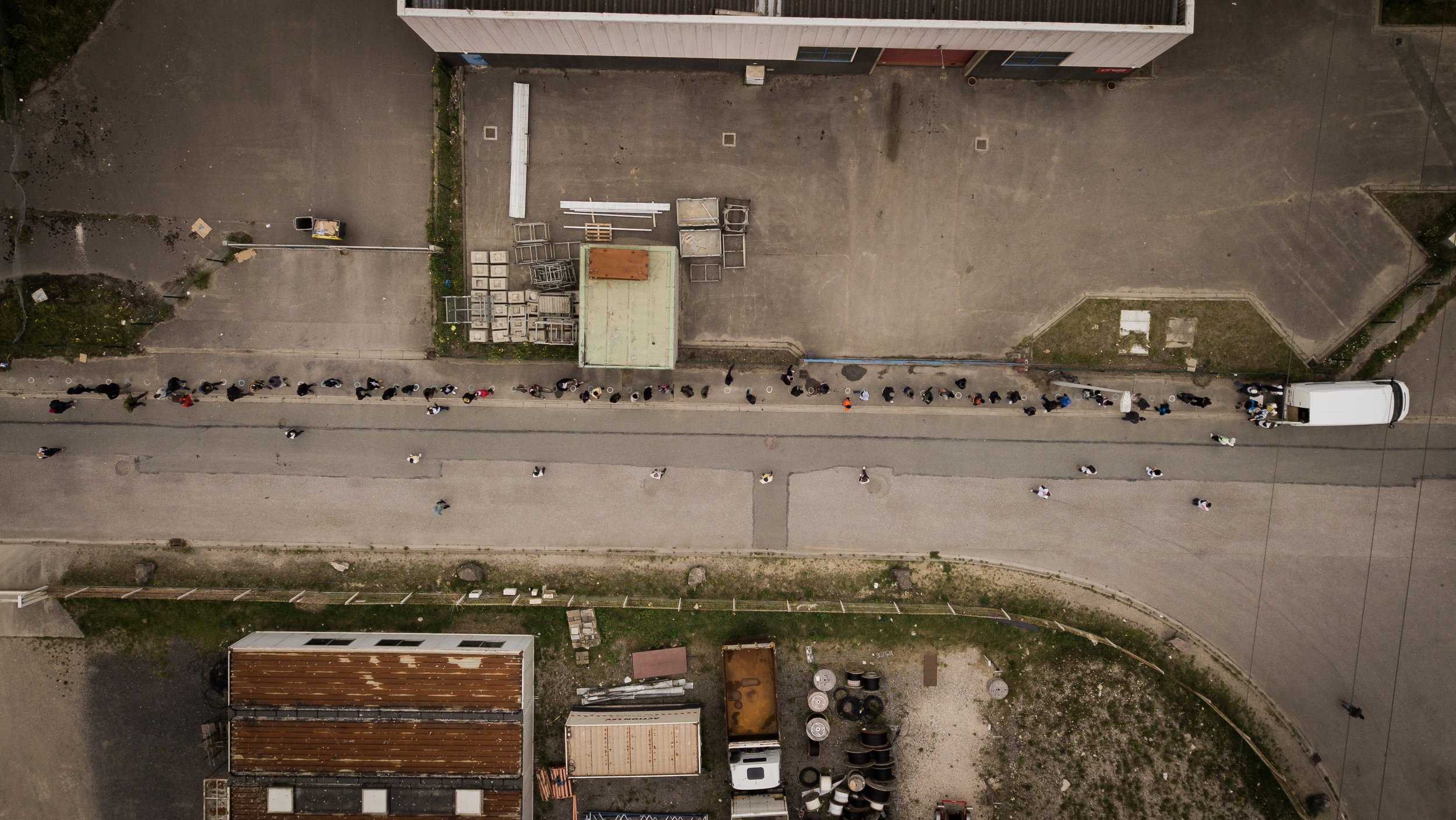  A long line of men, mostly from Sudan, queue patiently as they wait for local charity organisation @care4calais to distribute items (whether it be clothing, food or other essentials) .  Each refugee 'site' around Calais is home to a particular commu