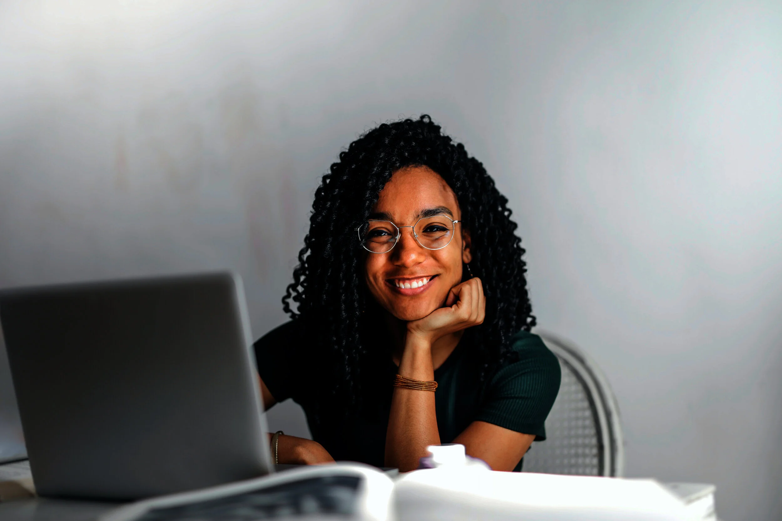 happy-ethnic-woman-sitting-at-table-with-laptop-new.jpg