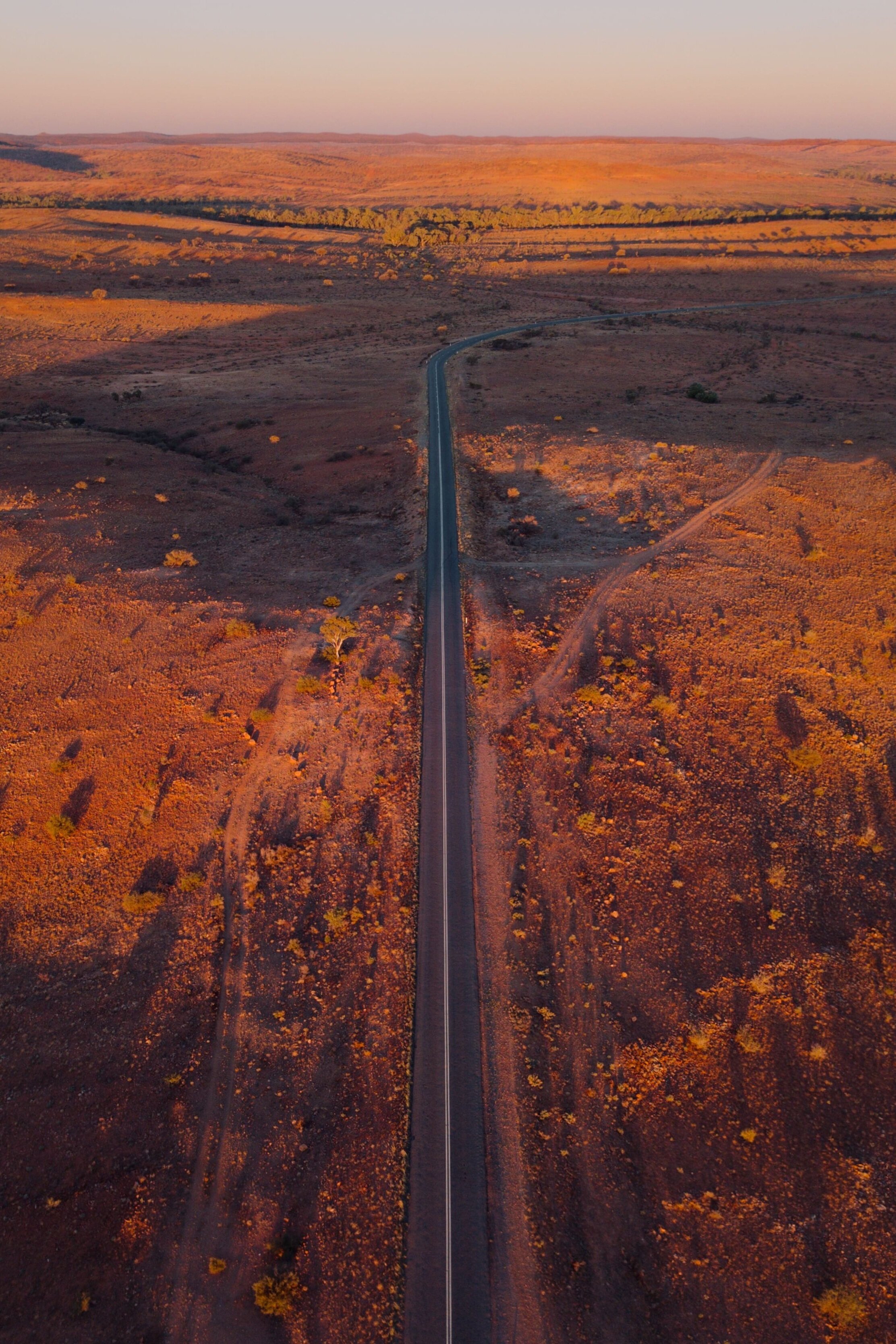 Aerial view of orange road in outback NSW