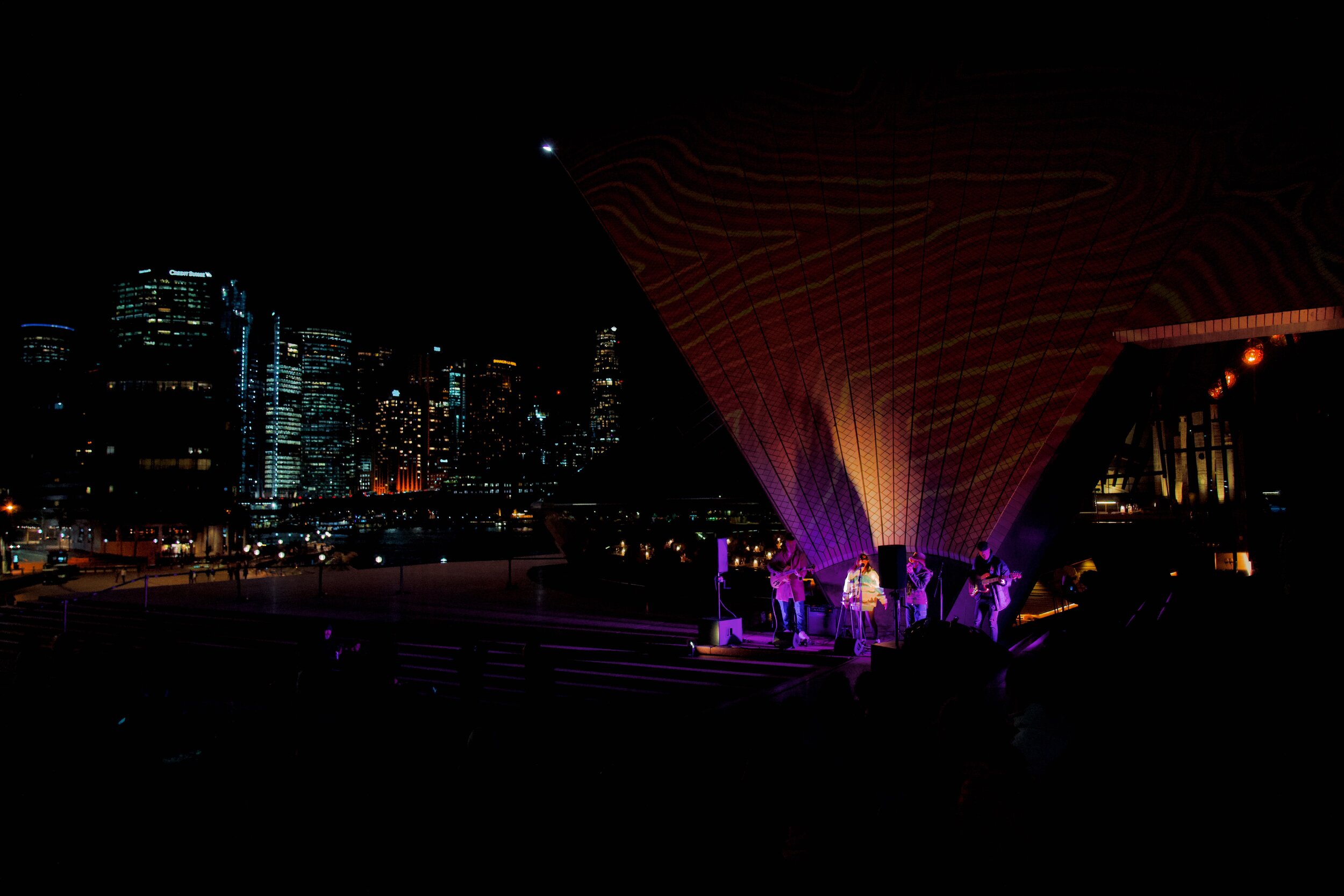 Srisha performing at the Sydney Opera House, sails lit up by First Nations artists