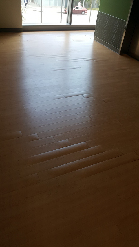 Luxury vinyl plank (LVP) doming and releasing from adhesive