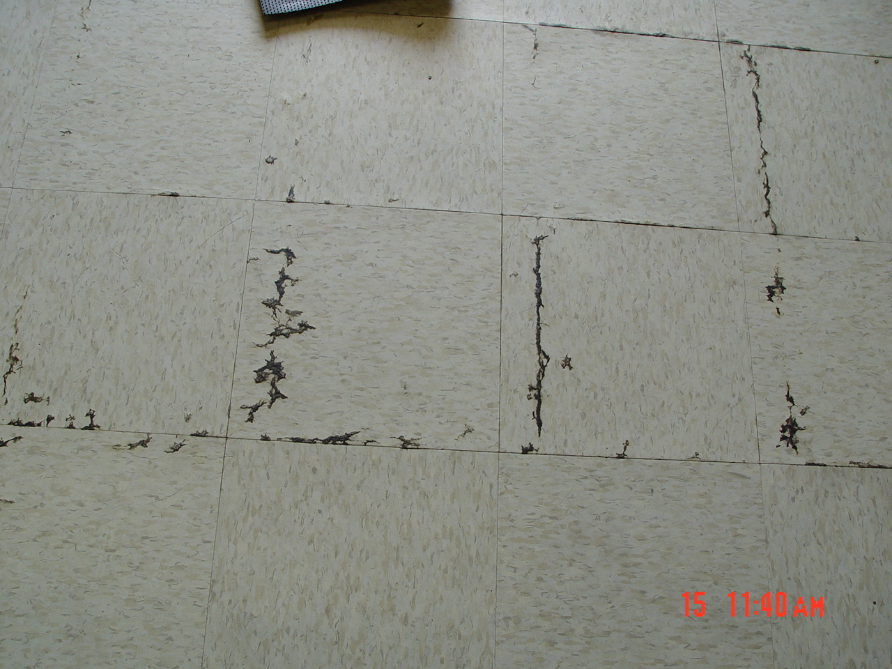 Moisture seepage from beneath a vinyl composition tile