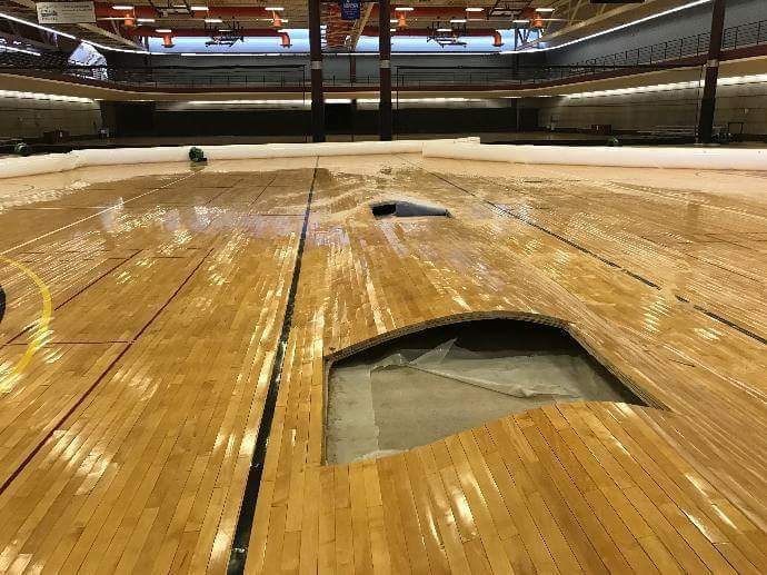 Hardwood gym floor buckled as a result of water intrusion