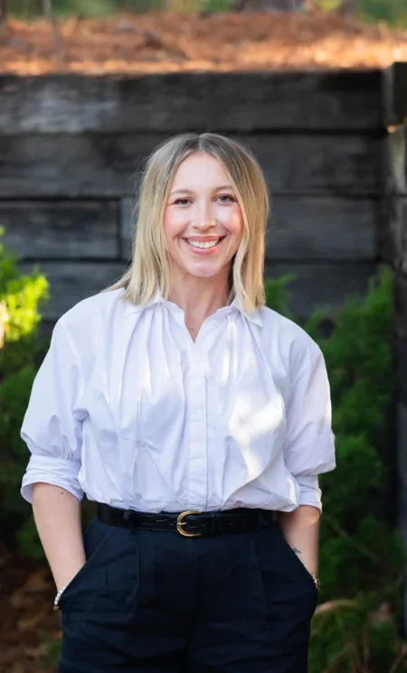 Licensed therapist from Iron City Counseling standing outdoors, smiling warmly, representing authentic, compassionate mental health care in Hoover and Birmingam, Alabama.