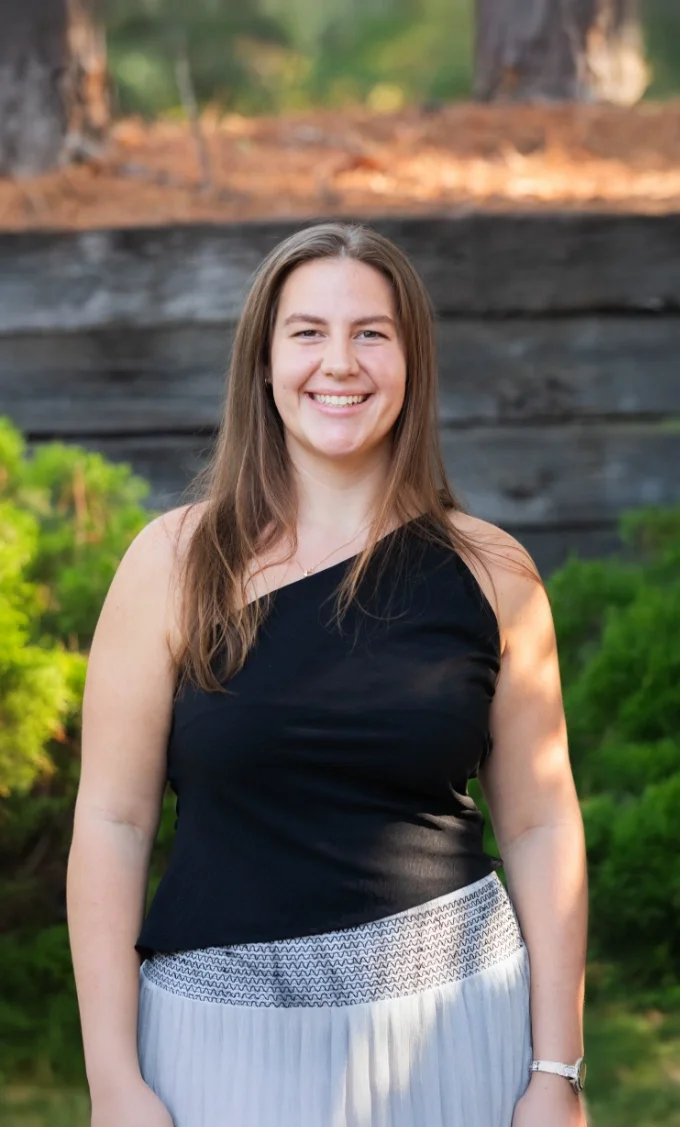 Ella Roth, office administrator at Iron City Counseling in Birmingham, Alabama, smiling outdoors and supporting client care coordination and practice operations.