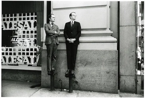 Paul McDonough, Two Men on Stand Pipes Watching Parade, 1975