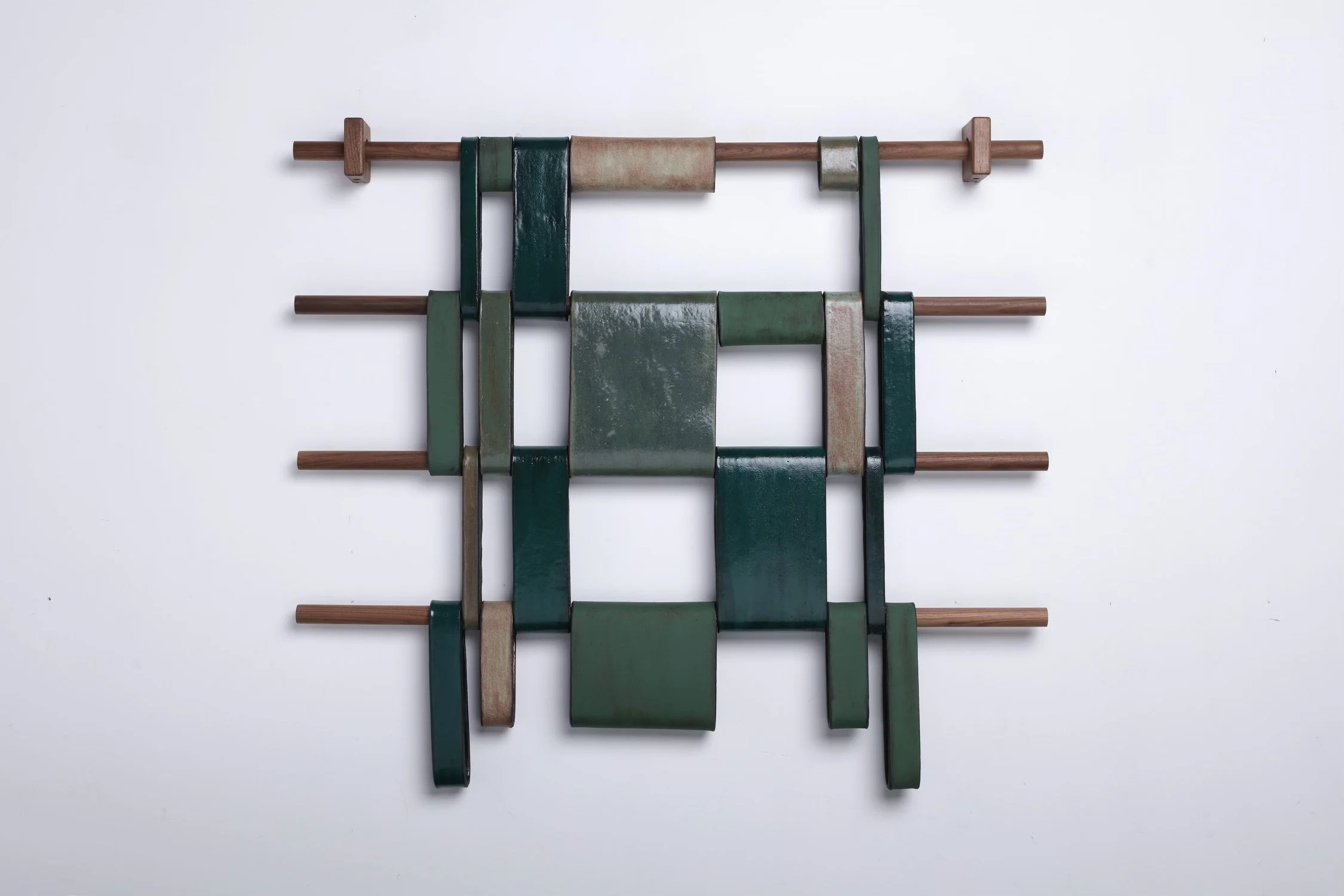 Susan McKinney, Optical Forest, 2025 Stoneware glazed in shades of green, with gloss, matte finishes, walnut dowels and mounts, 35 x 39 x 3 in.